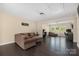Spacious living room features dark floors, a large sofa, and an adjacent bonus living space at 16827 Monocacy Blvd, Huntersville, NC 28078