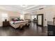Spacious main bedroom featuring dark wood floors, a large bed, and a bonus sitting area at 16827 Monocacy Blvd, Huntersville, NC 28078