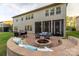 Paver patio features a fire pit with built-in seating, an outdoor kitchen, and comfortable lounge furniture at 16827 Monocacy Blvd, Huntersville, NC 28078