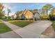 Well-maintained side yard with lush lawn, mature trees, and a brick-lined driveway at 16827 Monocacy Blvd, Huntersville, NC 28078