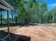 Cleared home lot featuring many trees behind the future screened-in porch at 552 Fern Hill Rd # 21, Mooresville, NC 28117