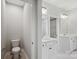 Bright bathroom features double sink vanity with white cabinets, neutral walls and tile floors at 552 Fern Hill Rd # 21, Mooresville, NC 28117