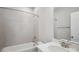 This bathroom features a shower-tub combo with gray tiled walls and a vanity with a white countertop at 552 Fern Hill Rd # 21, Mooresville, NC 28117