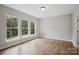 This bedroom features three large windows, wood flooring and neutral colored walls at 552 Fern Hill Rd # 21, Mooresville, NC 28117