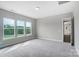 Bright bedroom featuring three large windows offering verdant, scenic views and neutral walls at 552 Fern Hill Rd # 21, Mooresville, NC 28117