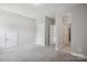Bedroom with neutral carpet, neutral walls, and three white doors at 552 Fern Hill Rd # 21, Mooresville, NC 28117