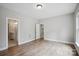 Spacious bedroom featuring wood flooring, neutral walls, and two doorways at 552 Fern Hill Rd # 21, Mooresville, NC 28117