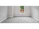 Bedroom features a single window and neutral colored carpeting at 552 Fern Hill Rd # 21, Mooresville, NC 28117