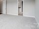 Spacious bedroom boasting soft carpet and a doorway that reveals a glimpse of the ensuite bathroom at 552 Fern Hill Rd # 21, Mooresville, NC 28117