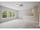 Bright bonus room featuring plush carpet and large windows offering abundant natural light at 552 Fern Hill Rd # 21, Mooresville, NC 28117