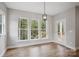 This dining area features wood-look flooring and multiple windows offering beautiful wooded views at 552 Fern Hill Rd # 21, Mooresville, NC 28117