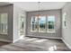 Open concept dining room with LVP flooring and natural light at 552 Fern Hill Rd # 21, Mooresville, NC 28117