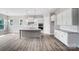 Spacious kitchen with gray island, white cabinets, stainless steel appliances, and tile backsplash at 552 Fern Hill Rd # 21, Mooresville, NC 28117