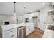 Open-concept kitchen with a large center island, stainless steel appliances, farmhouse sink and hardwood floors at 552 Fern Hill Rd # 21, Mooresville, NC 28117