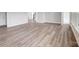 Open living room features beautiful gray wood floors and a neutral color scheme at 552 Fern Hill Rd # 21, Mooresville, NC 28117