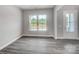 Light-filled living room with gray wood floors and a view of the outdoors at 552 Fern Hill Rd # 21, Mooresville, NC 28117