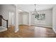 Open concept living room with wood floors, staircase, view from a window and neutral paint at 552 Fern Hill Rd # 21, Mooresville, NC 28117
