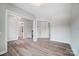Spacious living area with wood-look floors, open doorways and natural light at 552 Fern Hill Rd # 21, Mooresville, NC 28117