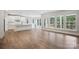 Spacious open-concept with hardwood floors, white kitchen, and large windows with backyard view at 552 Fern Hill Rd # 21, Mooresville, NC 28117