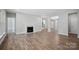Spacious living room with fireplace, wood-look floors, and an open floor plan at 552 Fern Hill Rd # 21, Mooresville, NC 28117