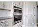 Stainless steel double oven with white cabinets and granite countertops at 552 Fern Hill Rd # 21, Mooresville, NC 28117