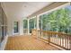 Spacious covered porch with wood flooring and railing, offering a serene outdoor space at 552 Fern Hill Rd # 21, Mooresville, NC 28117