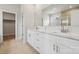 Bathroom featuring double sink vanity with white cabinets, quartz counters, and tile flooring at 227 E Warfield Dr, Mooresville, NC 28115