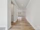 Bright hallway with wood-look floors, leading to an open living space at 227 E Warfield Dr, Mooresville, NC 28115