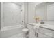 Clean bathroom with marble tile, a white vanity, and a bathtub at 7073 Stella Pl, Stanley, NC 28164