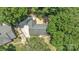 Aerial view of the home showcasing mature trees, roof, and driveway at 1003 Woodland Dr, Gastonia, NC 28054