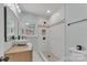 Updated bathroom with a bright white tile shower, niche, modern fixtures, and elegant vanity at 1003 Woodland Dr, Gastonia, NC 28054