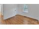 Bright bedroom featuring hardwood floors, a window, and a closet at 1003 Woodland Dr, Gastonia, NC 28054