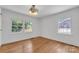 Bright bedroom with pristine white walls, hardwood floors and two windows bringing in natural light at 1003 Woodland Dr, Gastonia, NC 28054