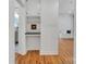 Hallway featuring white cabinets and a view of the living room with bench seating at 1003 Woodland Dr, Gastonia, NC 28054