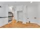 Bright kitchen showcasing stainless steel appliances, white cabinets and hardwood floors at 1003 Woodland Dr, Gastonia, NC 28054