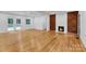 Open living room featuring hardwood floors, fireplace and french doors to backyard at 1003 Woodland Dr, Gastonia, NC 28054