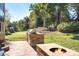 Patio with fire pit and grill overlooking large backyard space at 15909 Woodcote Dr, Huntersville, NC 28078