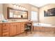 Bathroom featuring a tub, vanity and an oversized mirror at 15909 Woodcote Dr, Huntersville, NC 28078