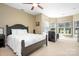 Bedroom with a ceiling fan and large windows at 15909 Woodcote Dr, Huntersville, NC 28078