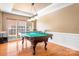 Game room with pool table, natural light, and ample space for entertainment at 15909 Woodcote Dr, Huntersville, NC 28078