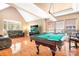 Spacious game room with a pool table, comfortable seating, and ample natural light at 15909 Woodcote Dr, Huntersville, NC 28078