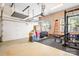 Spacious garage featuring overhead storage racks and workout equipment at 15909 Woodcote Dr, Huntersville, NC 28078