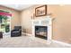 Comfortable living room featuring a fireplace, neutral carpet, and a cozy armchair at 15909 Woodcote Dr, Huntersville, NC 28078