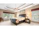 Bedroom with a tray ceiling and multiple windows at 15909 Woodcote Dr, Huntersville, NC 28078