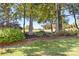 Beautifully landscaped yard with fresh mulch and mature trees at 15909 Woodcote Dr, Huntersville, NC 28078