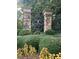 Stone pillar entrance to Highgate community, featuring lush landscaping and a decorative wrought iron gate at 2097 Kings Manor Dr # 53, Matthews, NC 28104