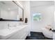 Modern bathroom featuring a double sink vanity and a freestanding soaking tub with a large window view at 2107 W Trade St, Charlotte, NC 28216