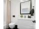 Modern bathroom featuring a floating vanity, black fixtures, and shower with curtain at 2107 W Trade St, Charlotte, NC 28216