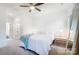 Bright bedroom with a ceiling fan, a comfortable bed, and minimalist decor for a relaxing atmosphere at 2107 W Trade St, Charlotte, NC 28216