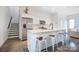 Modern kitchen featuring stainless steel appliances, a spacious island with bar seating, and sleek white cabinets at 2107 W Trade St, Charlotte, NC 28216